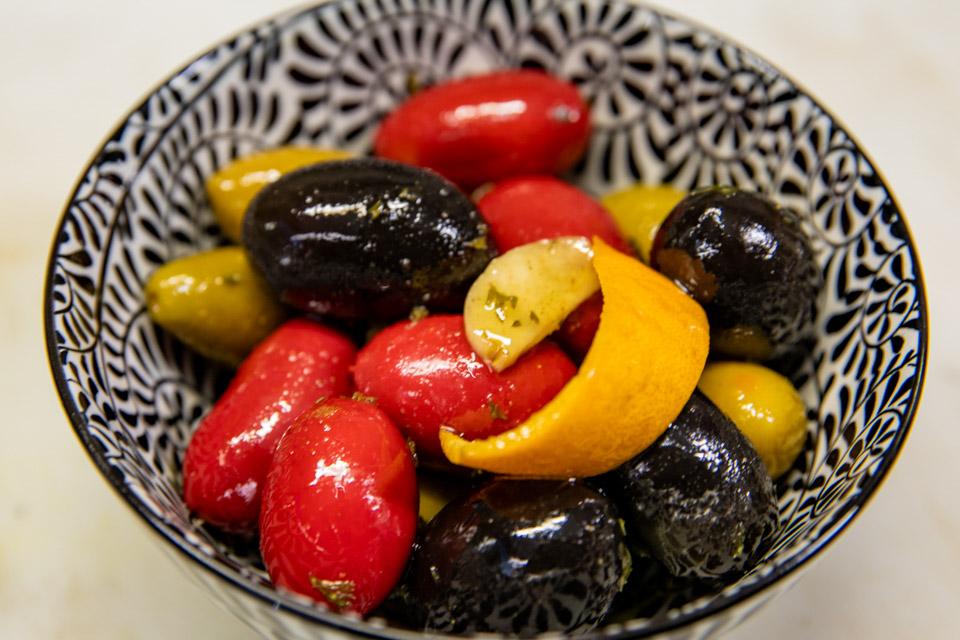 Marinated olives with fresh herbs, garlic, and orange peel.