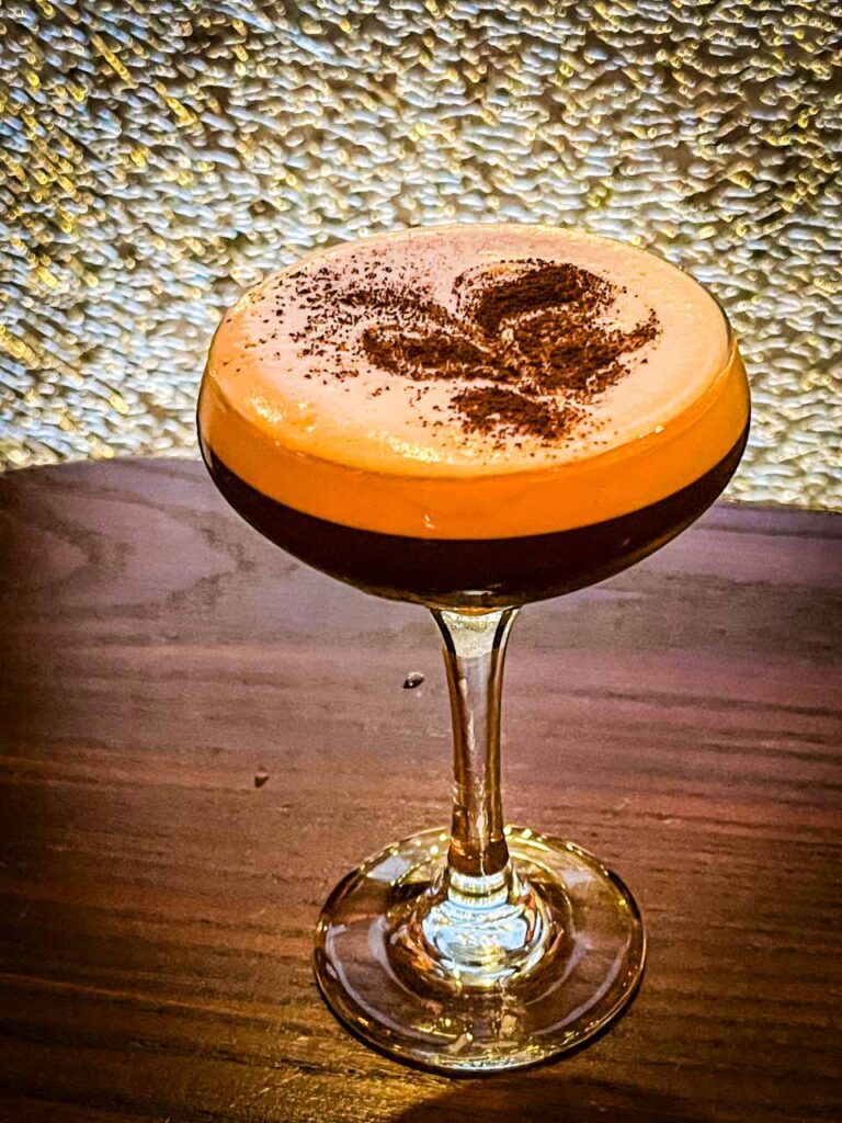 A sophisticated Espresso Martini cocktail at Simone on Sunset, featuring a smooth blend of Reyka Vodka, Borghetti Espresso Liqueur, freshly brewed espresso, turbinado sugar, and a hint of orange oils, served in a chilled martini glass.