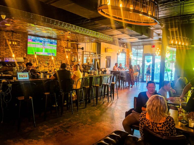 Cozy interior of Simone on Sunset, a premier wine bar in Houston, featuring elegant seating, dim lighting, and an extensive selection of wines