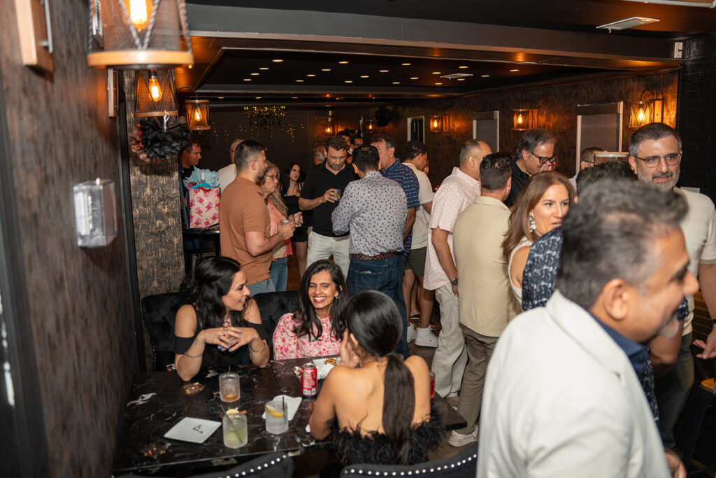 Guests attending a company holiday party at Simone on Sunset in Houston.