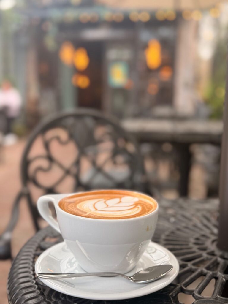 Coffee Rice Village Houston – latte served on the patio at Simone on Sunset