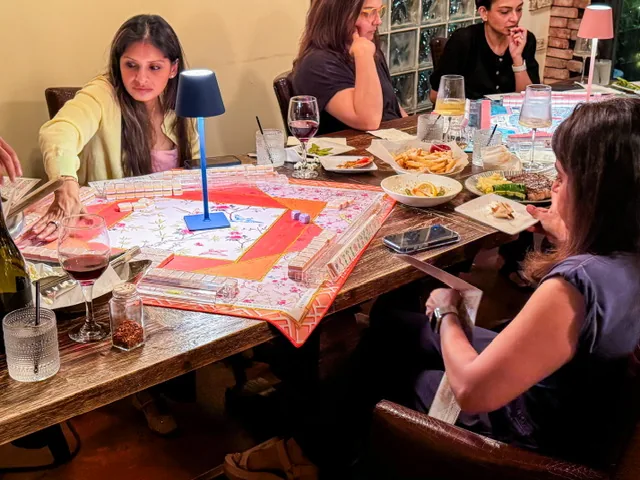 Friends playing at Monday mahjong night in Houston at Simone on Sunset in Rice Village